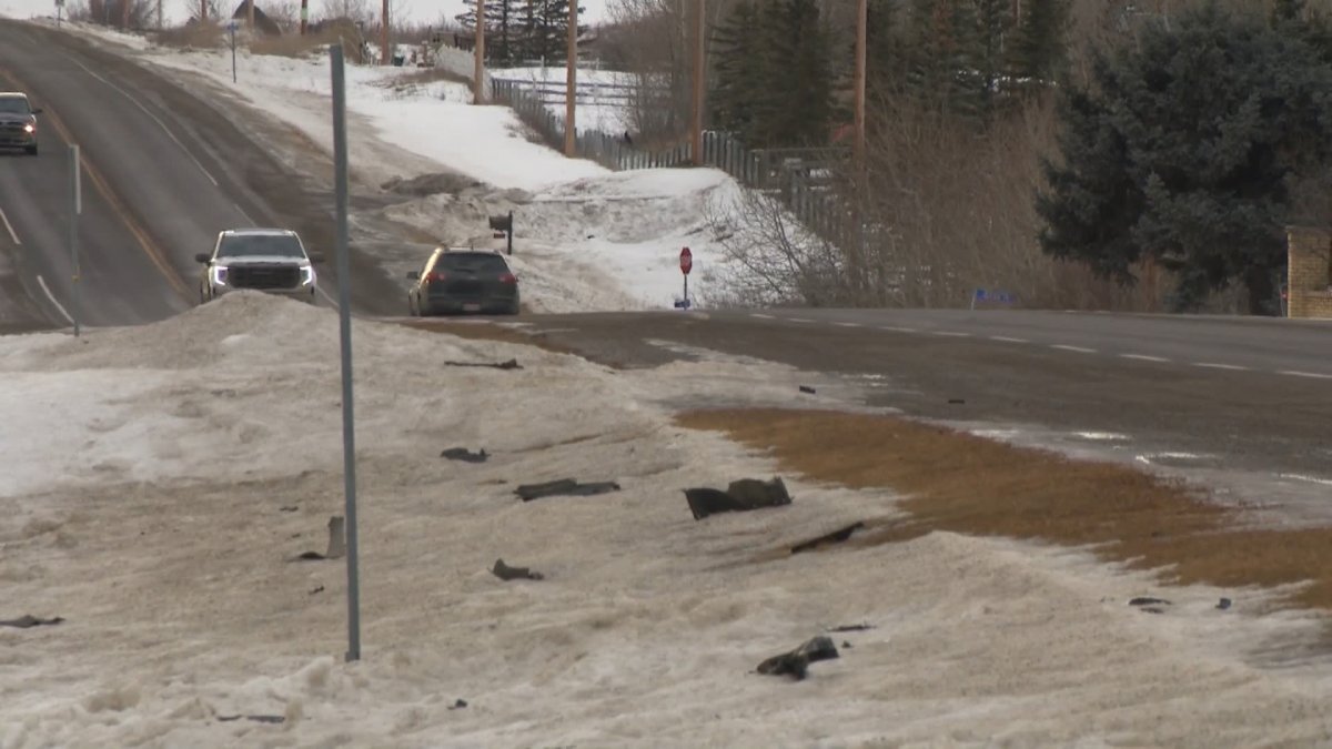 Vehicle debris is pictured on the side of Dunbow Road East, south of Calgary, on Jan. 29, 2024.