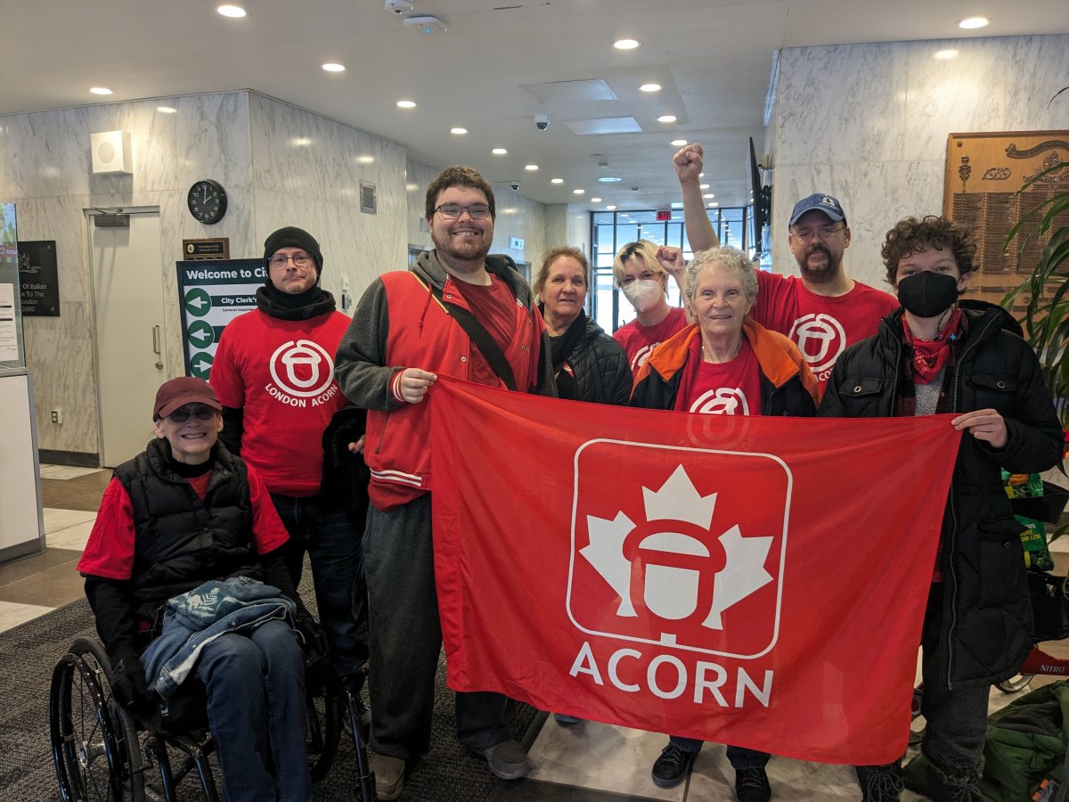 Members of ACORN London stand in city hall after a tenant rights motion passed through committee successfully.