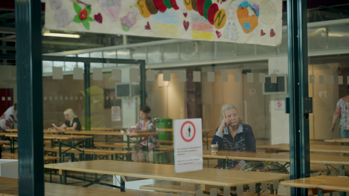 A woman waits in the area where dinner will be served.