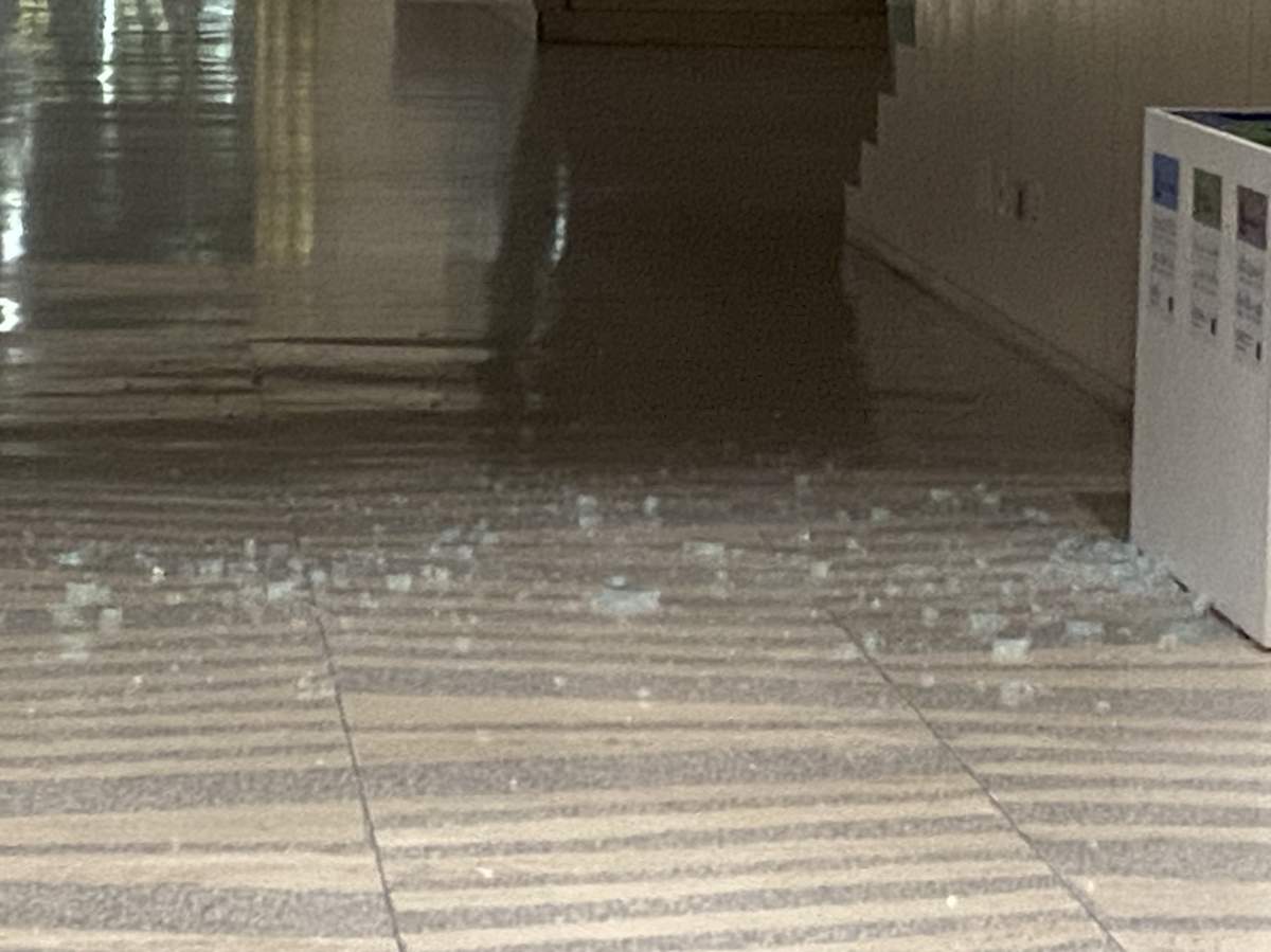Shattered glass on the floor of Edmonton City Hall Wednesday, Jan. 24, 2024, one day after a shooting inside the building.
