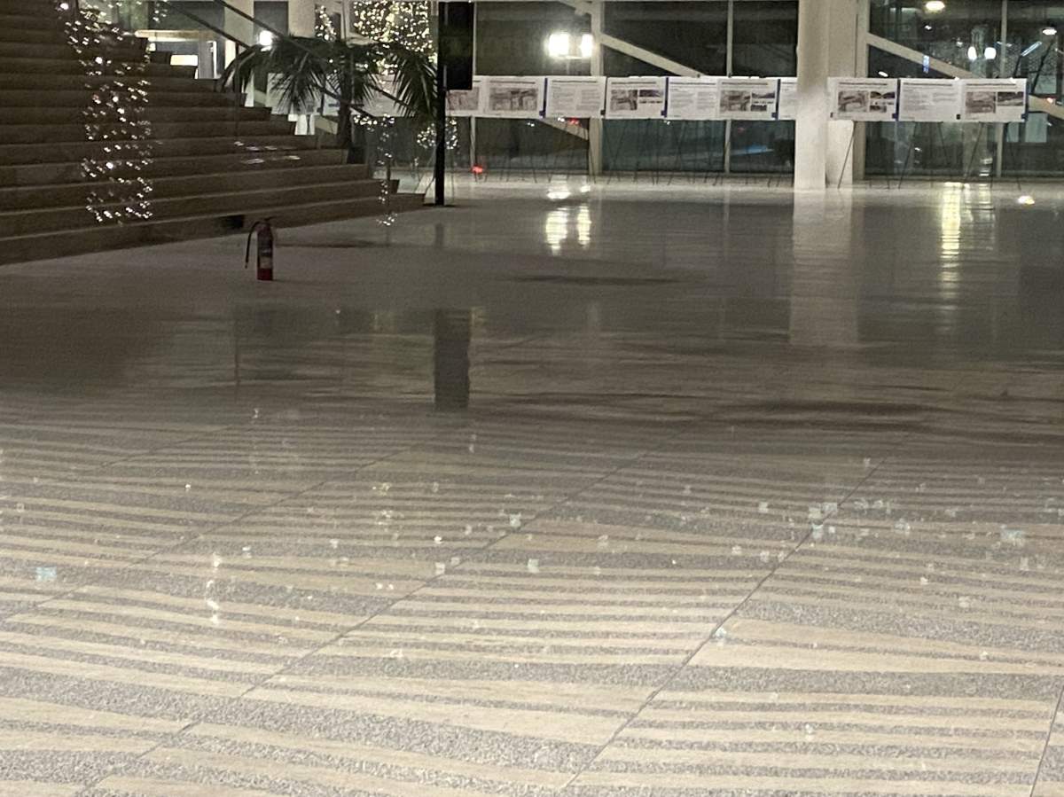 Shattered glass on the floor of Edmonton City Hall Wednesday, Jan. 24, 2024, one day after a shooting inside the building.