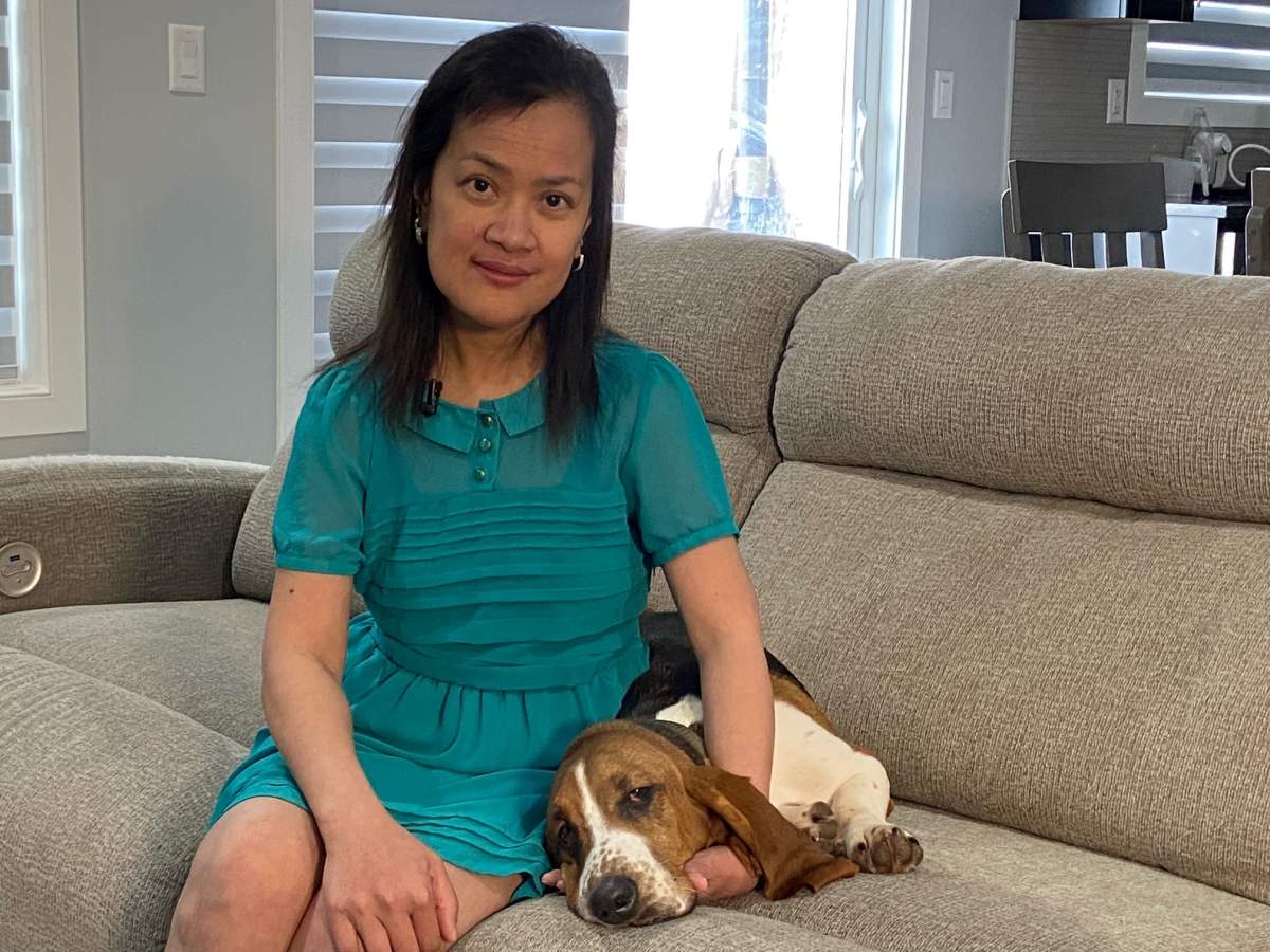 Teresa Nisperos and her basset hound Gus.