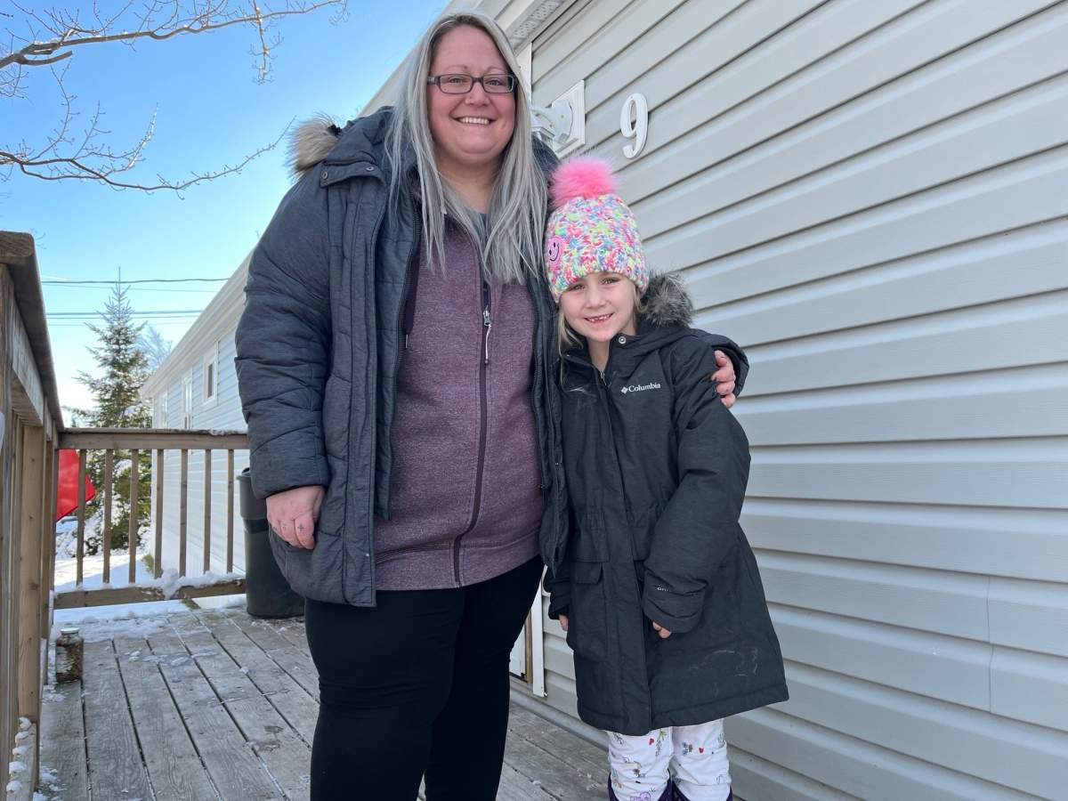 Jennifer Allain stands with her six-year-old daughter