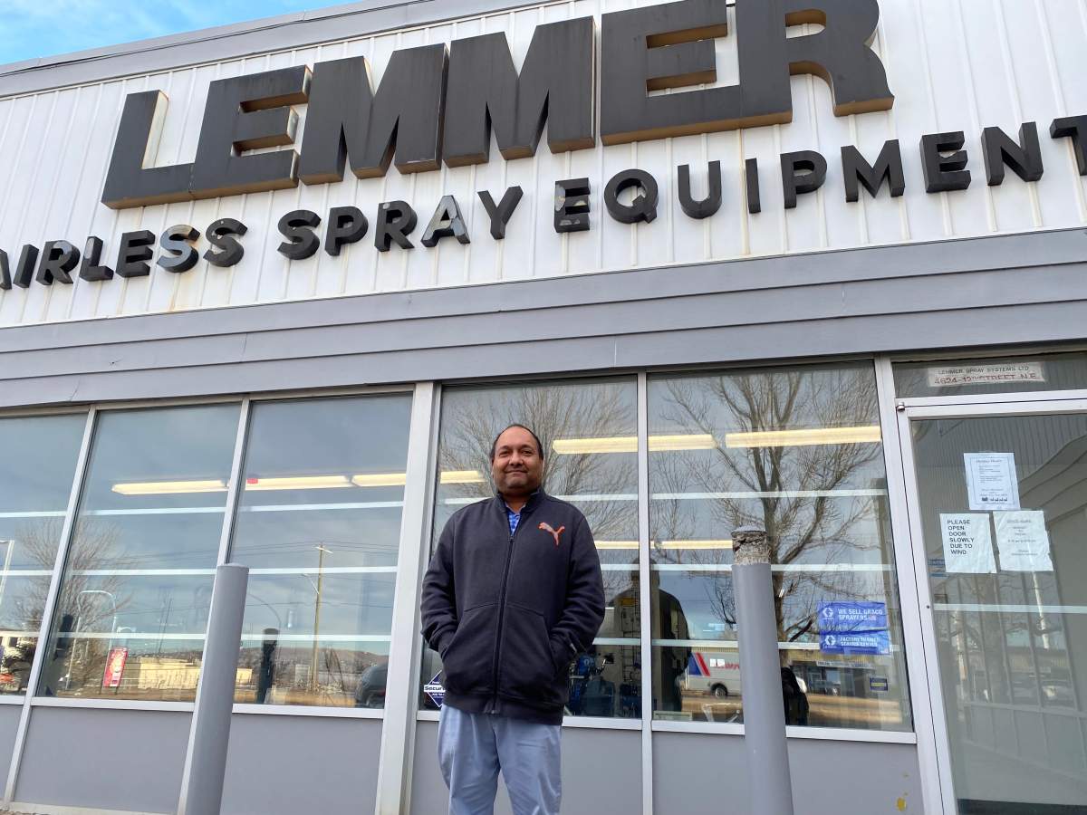 Hussein Bawa standing in front of his business