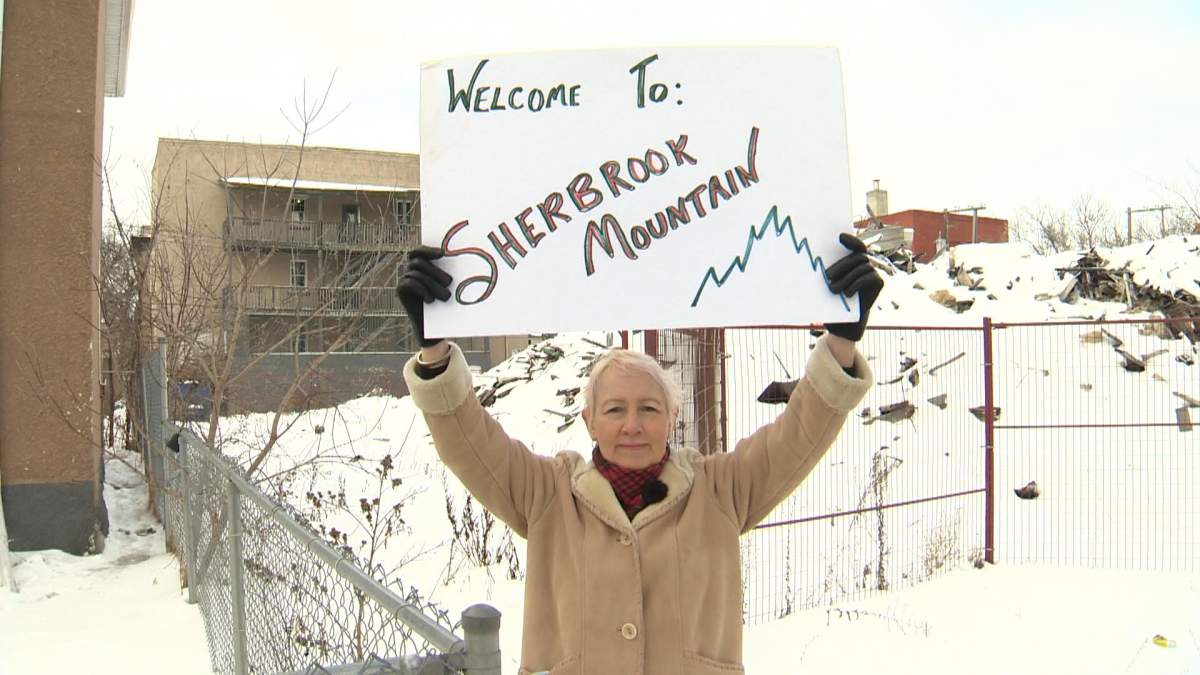Cheryl Martens, Winnipeg Spence neighbourhood resident standing infront of a mountain of rubble.