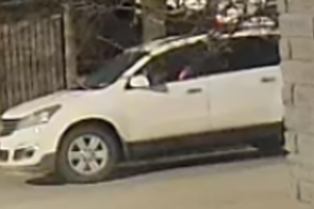 Police released an image of a white SUV which they say has a burnt-out headlight on the passenger while saying they are looking to identify the driver of the vehicle.