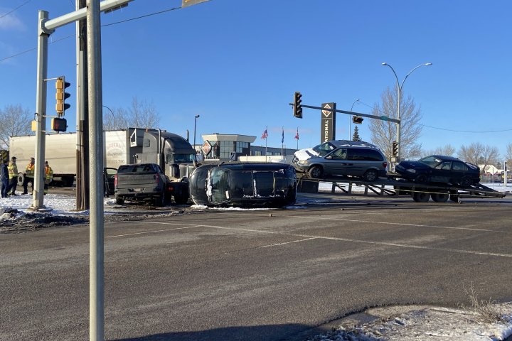 Flat deck trailer topples in west Edmonton collision, blocking intersection