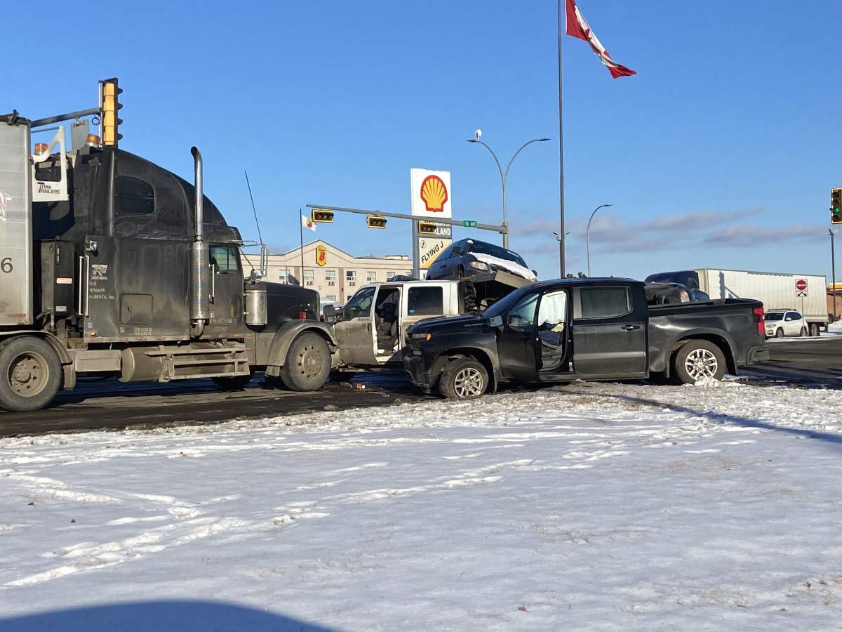 Collision between a pickup truck and the flat deck trailer at the intersection of 170 Street and 118 Avenue on Feb. 9, 2024.
