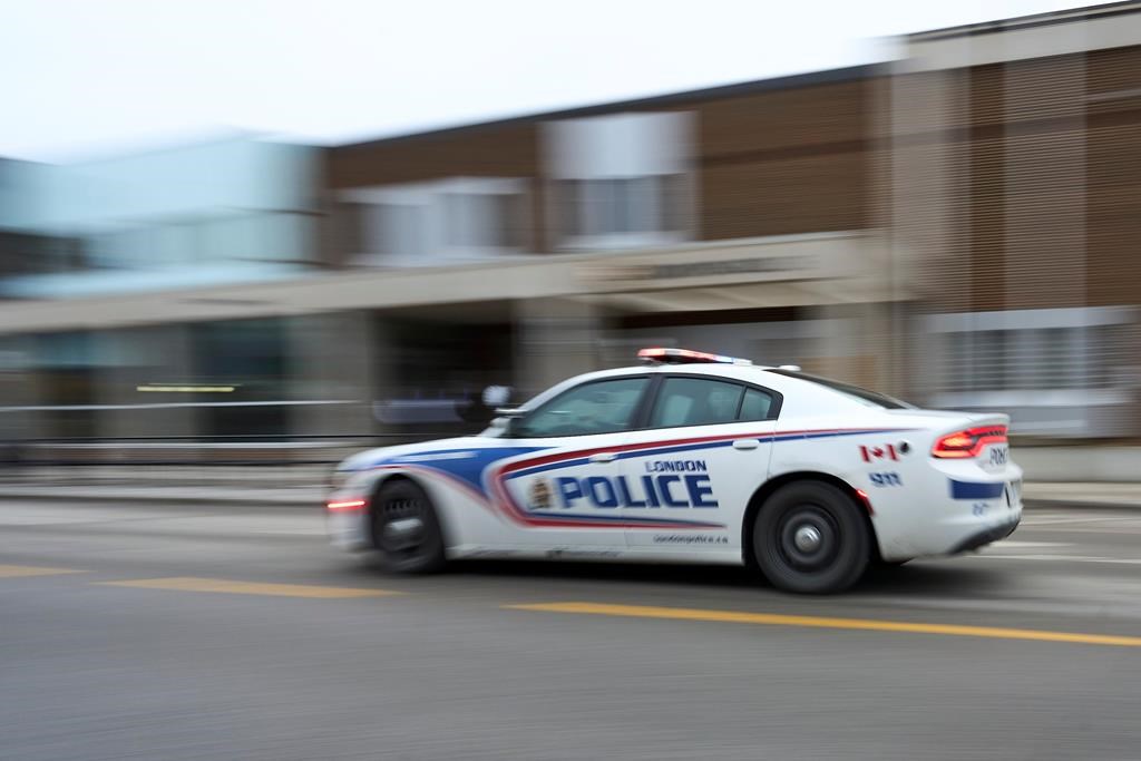 A line is forming outside a London, Ont., courthouse where the sexual assault case against five former members of Canada's world junior hockey team is set to be heard today. A police car drives by London Police headquarters in London, Ont., Monday, Jan. 29, 2024. THE CANADIAN PRESS/Geoff Robins.