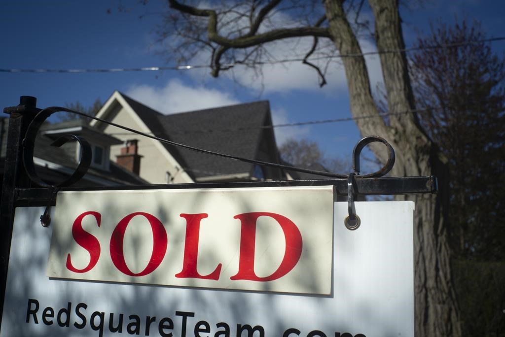A real estate sold sign is shown in a Toronto west end neighbourhood May 16, 2020. THE CANADIAN PRESS/Graeme Roy.
