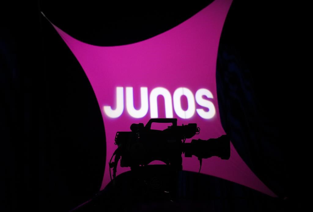 A video camera is silhouetted as people gather for a press conference for last year's Juno Award nominations in this file photo.