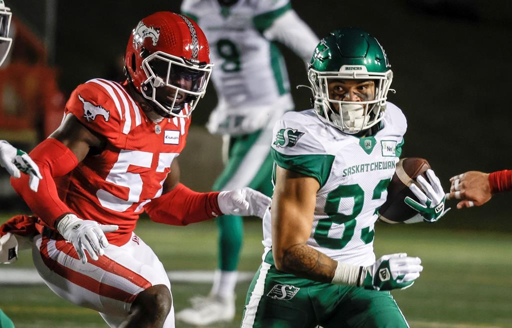 Saskatchewan Roughriders wide receiver Jerreth Stern, right, gets past Calgary Stampeders linebacker Micah Awe during first half CFL football action in Calgary, Friday, Oct. 13, 2023. Awe won't be hitting CFL free agency. The veteran American linebacker signed a contract extension with the Calgary Stampeders on Friday. Awe was eligible to become a CFL free agent Tuesday. THE CANADIAN PRESS/Jeff McIntosh