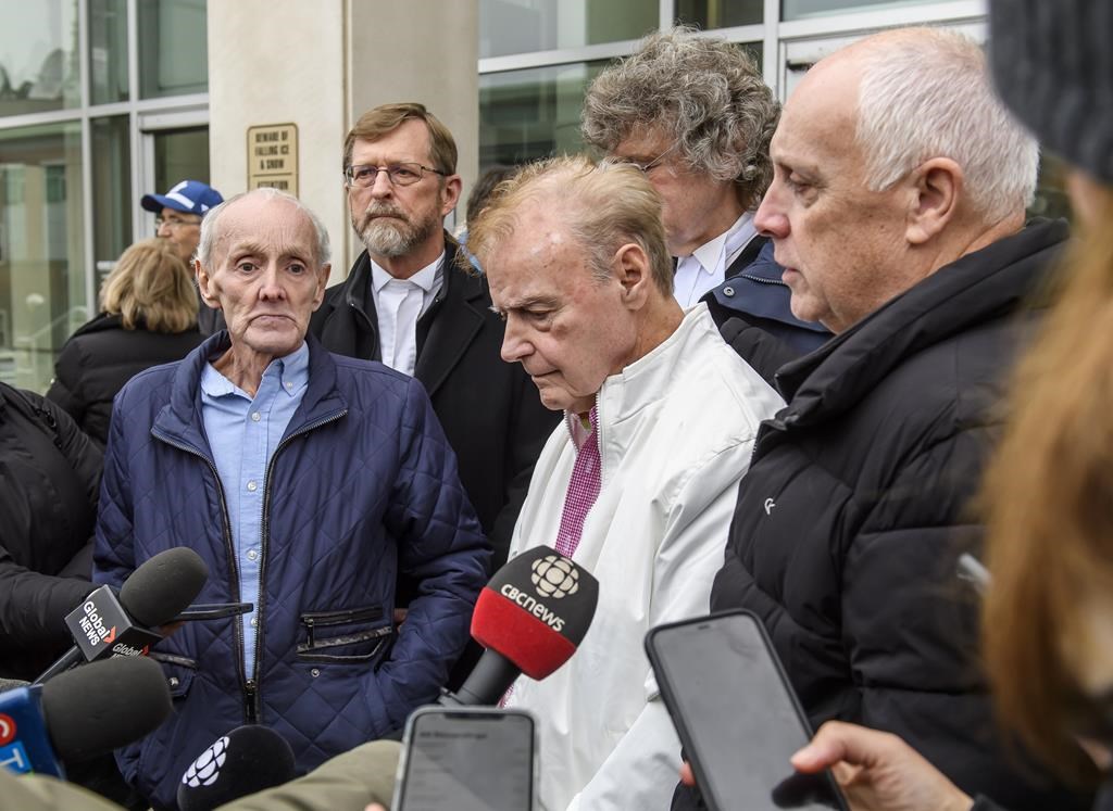 Robert Mailman, left, and Walter Gillespie, speak to media shortly after their hearing at Saint John Law Courts in Saint John, N.B., January 4, 2024. More than a month after they were declared innocent, lawyers for two New Brunswick men say they are in negotiations with the provincial government for compensation. THE CANADIAN PRESS/Michael Hawkins.
