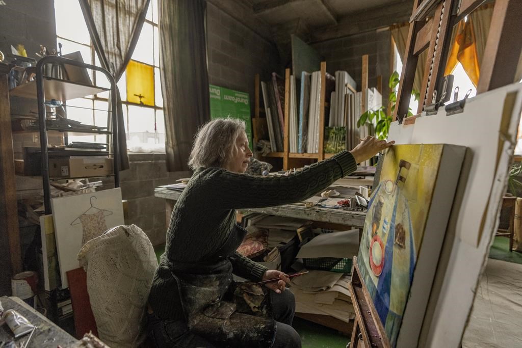 Artist Frances Foster works in her home in Montreal, Friday, Feb. 9, 2024. THE CANADIAN PRESS/Christinne Muschi.