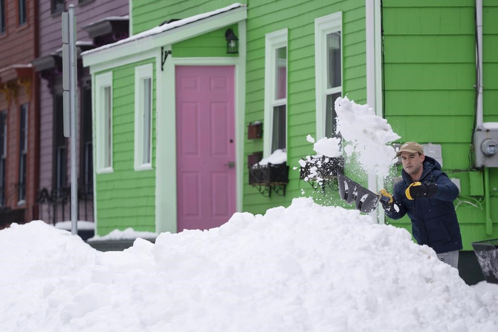 Guide dog and wheelchair users in Halifax say sidewalks still caked in snow and ice a week after a major snowstorm hit the province has meant that getting around the city is dangerous and in some cases impossible. A person shovels snow in Halifax on Monday, February 5, 2024. THE CANADIAN PRESS/Darren Calabrese.