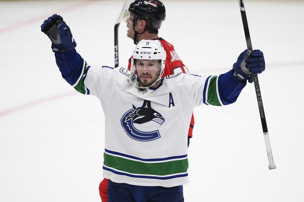 Vancouver Canucks center J.T. Miller (9) celebrates after his winning goal during overtime of an NHL hockey game against the Washington Capitals on Feb. 11, 2024, in Washington.