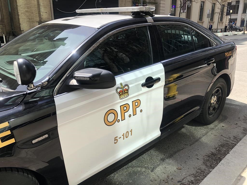 An Ontario Provincial Police vehicle sits idle in downtown Toronto, Tuesday, April 11, 2023.