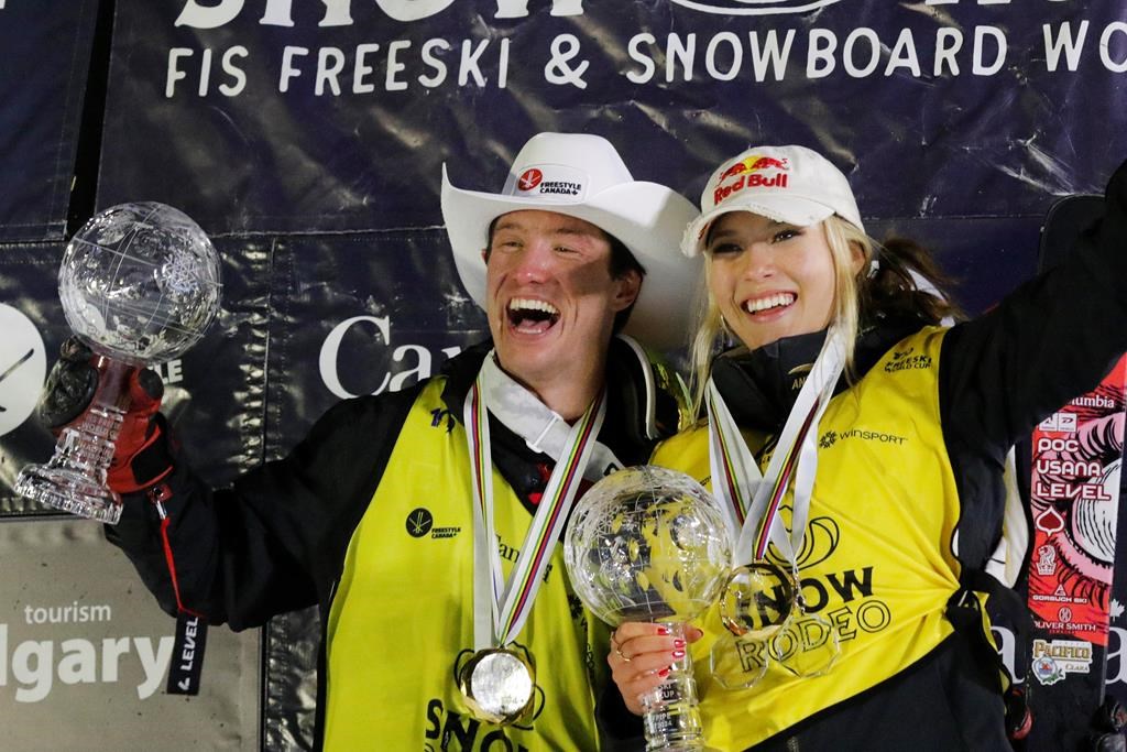 United States' Alex Ferreira and China's Ailing Eileen Gu celebrate their respective wins in the FIS World Cup freeski halfpipe finals as well as both finishing first in the overall season competition in Calgary on Saturday, Feb. 17, 2024. THE CANADIAN PRESS/Dave Chidley