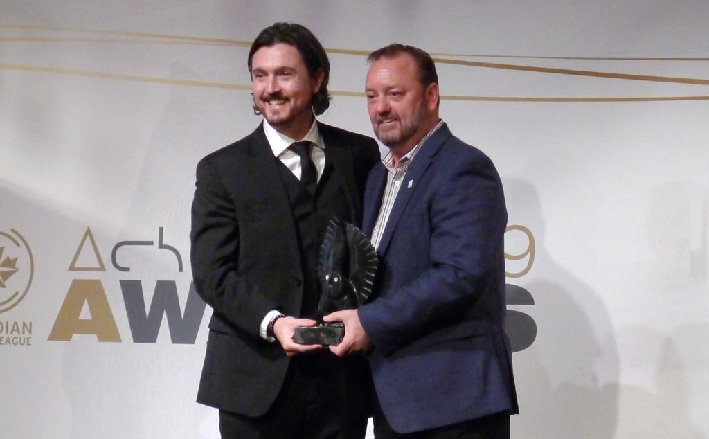 Cavalry FC’s Tommy Wheeldon Jr. receives his coach of the year award from commissioner David Clanachan.