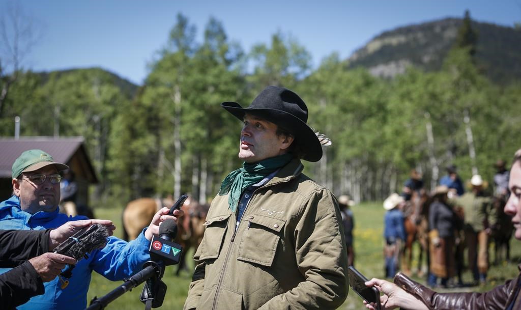 Singer and Alberta farmer Corb Lund, centre, speaks to media on land proposed for coal mine development in the eastern slopes of the Livingstone range southwest of Longview, Alta., Wednesday, June 16, 2021. 