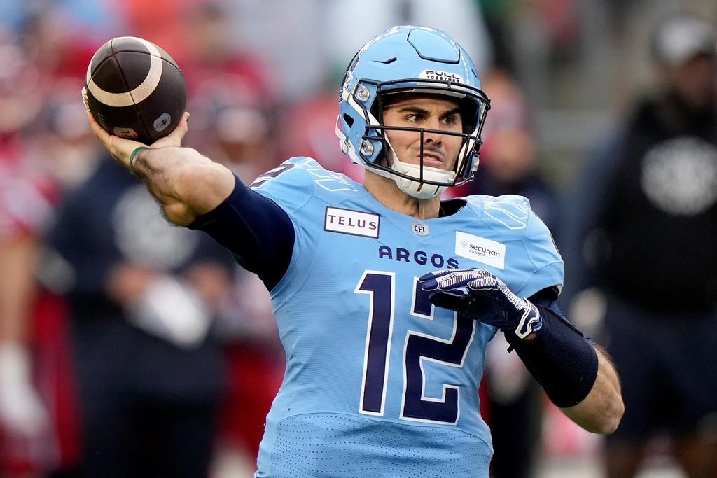 Toronto Argonauts quarterback Chad Kelly (12) makes the pass during first half CFL Eastern Division final football action against the Montreal Alouettes, in Toronto, Saturday, Nov. 11, 2023. The CFL says it's investigating after a lawsuit was issued by a former Toronto Argonauts strength-and-conditioning coach against the club for wrongful dismissal and quarterback Chad Kelly for alleged violations of the Ontario Human Rights Code. 