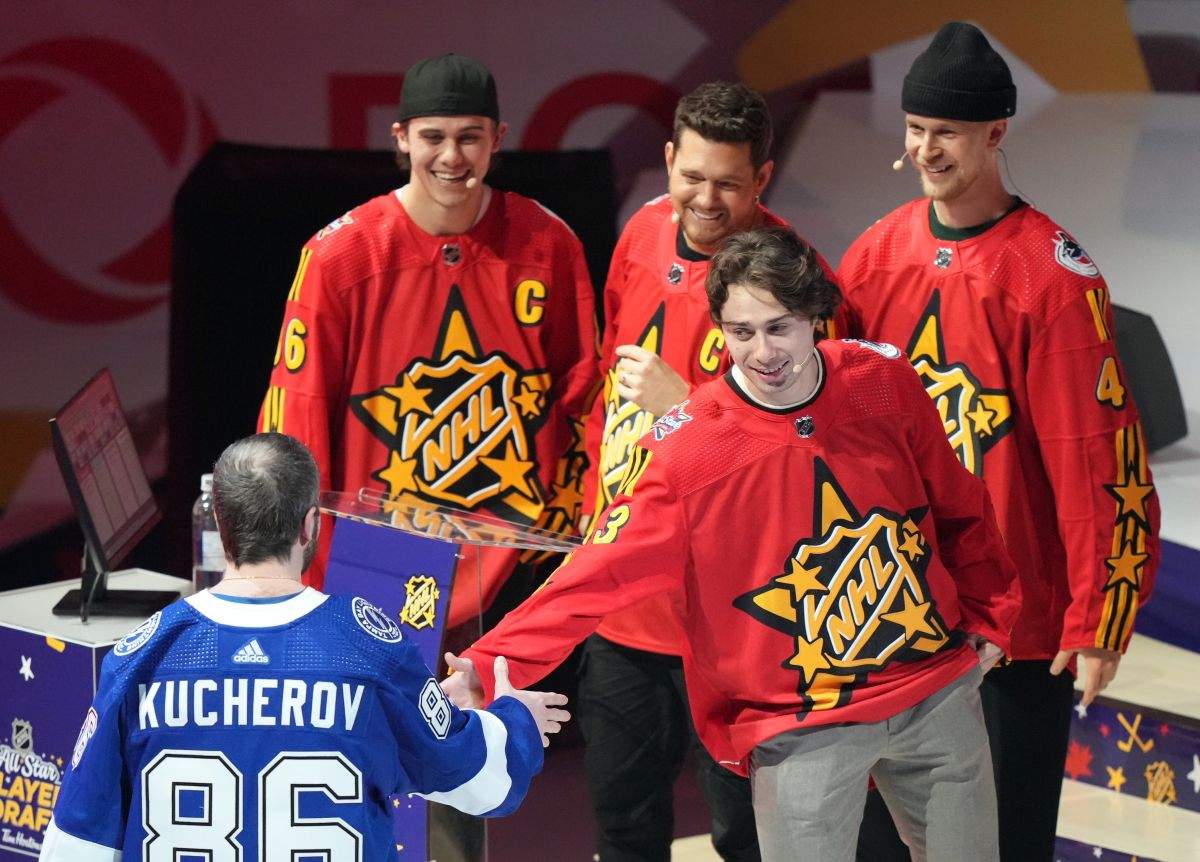 Quinn Hughes of Team Hughes, second right, picks Nikita Kucherov as fellow team members Jack Hughes (left), Michael Buble and Elias Pettersson (right) look on during the NHL All-Star week draft in Toronto on Thursday, February 1, 2024.
