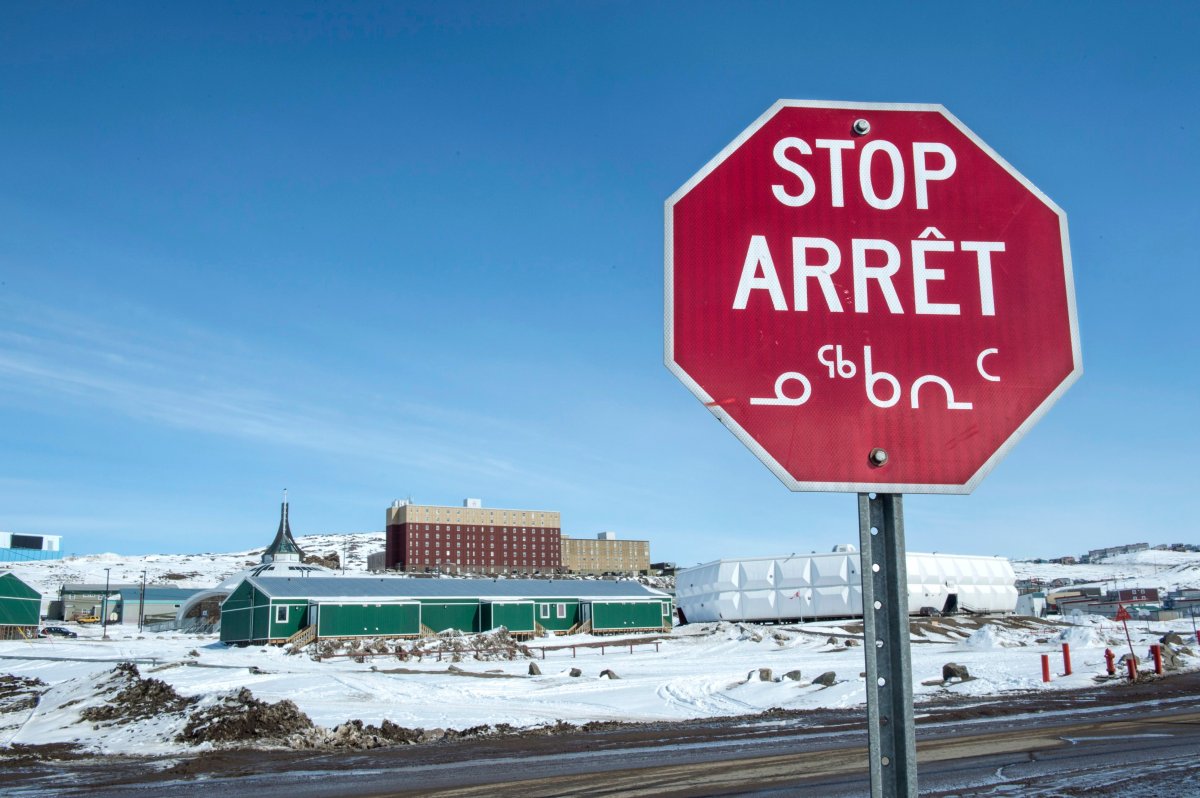 A stop sign is written in english, french and inuktitut