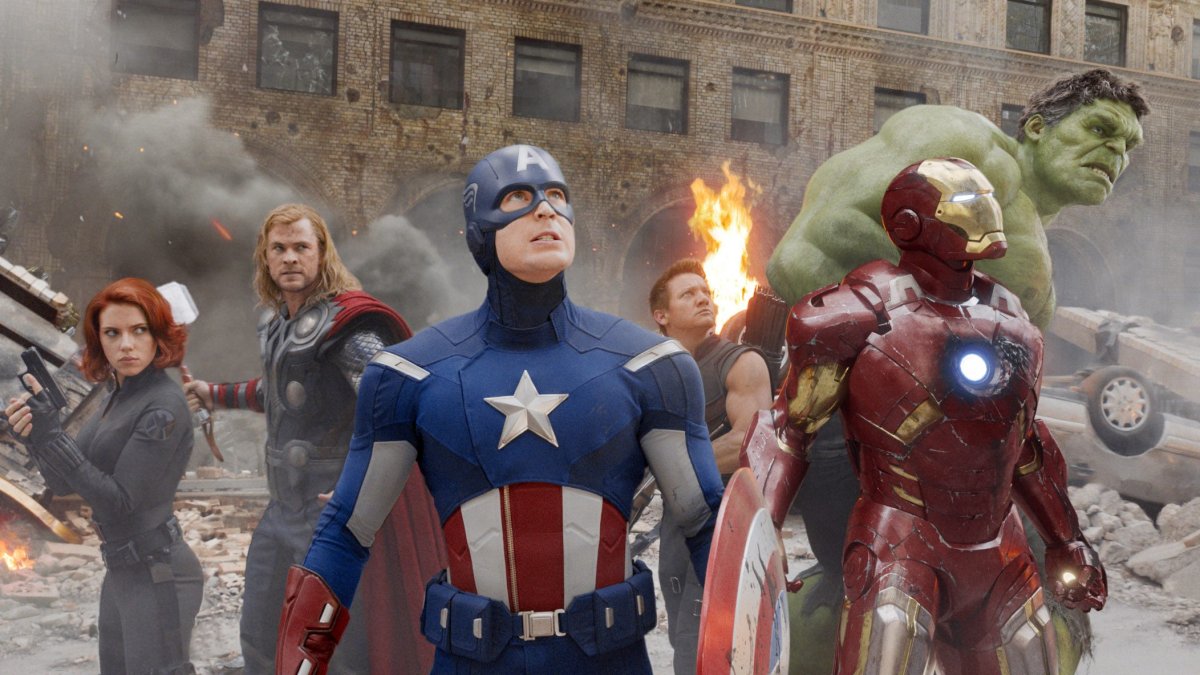 The Avengers standing together. Captain America is in the centre. They are looking upward. THE AVENGERS, from left: Scarlett Johansson as Black Widow, Chris Hemsworth as Thor, Chris Evans as Captain America, Jeremy Renner as Hawkeye, Robert Downey Jr as Iron Man, Mark Ruffalo as The Hulk