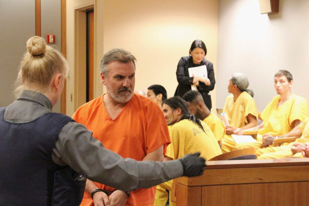 FILE – Brian Steven Smith, second from left, is escorted out of a courtroom in Anchorage, Alaska, Monday, Oct. 21, 2019.