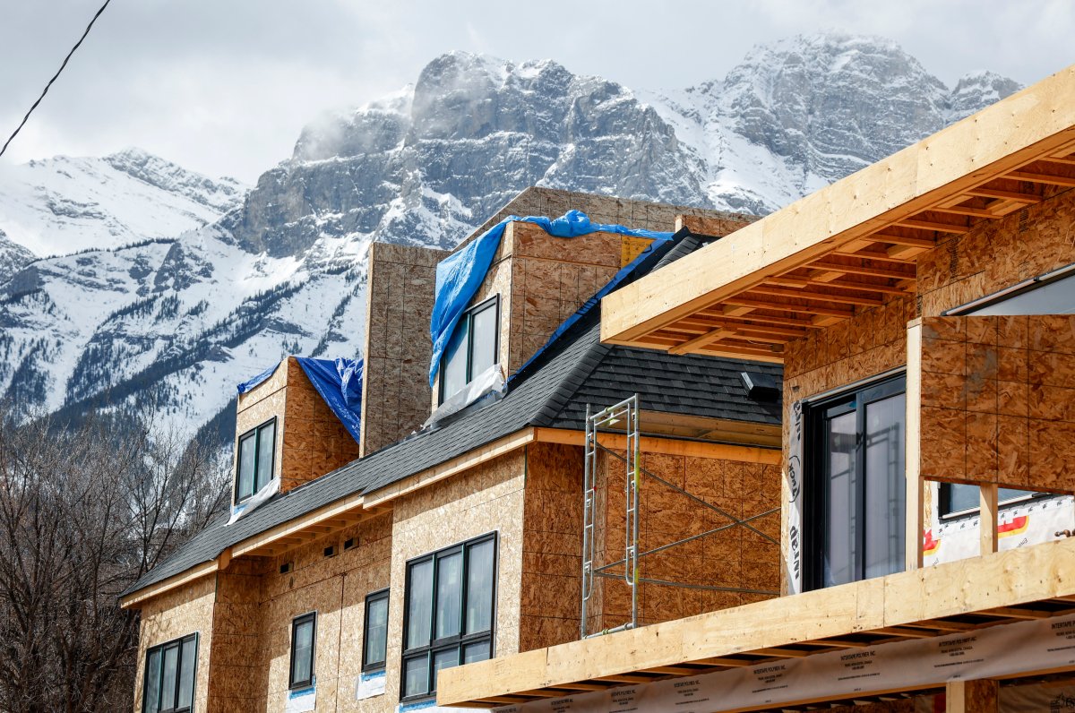 Mountains loom over condos being constructed in Canmore, Alta., Monday, April 24, 2023.