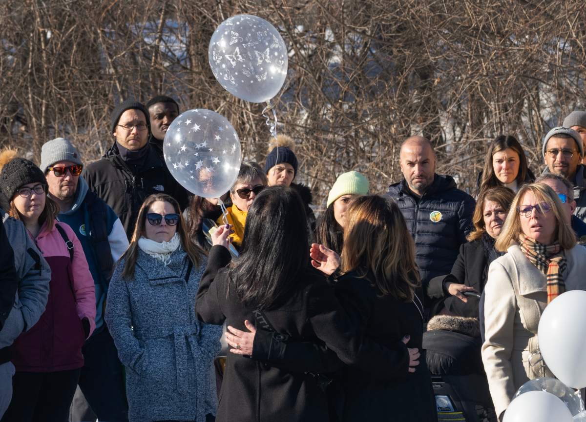 Two daycare employees release two ballons during a ceremony to commemorate the one year anniversary of the bus crash into a daycare that killed two children and injured six others, in Laval, Que., Thursday, Feb. 8, 2024.