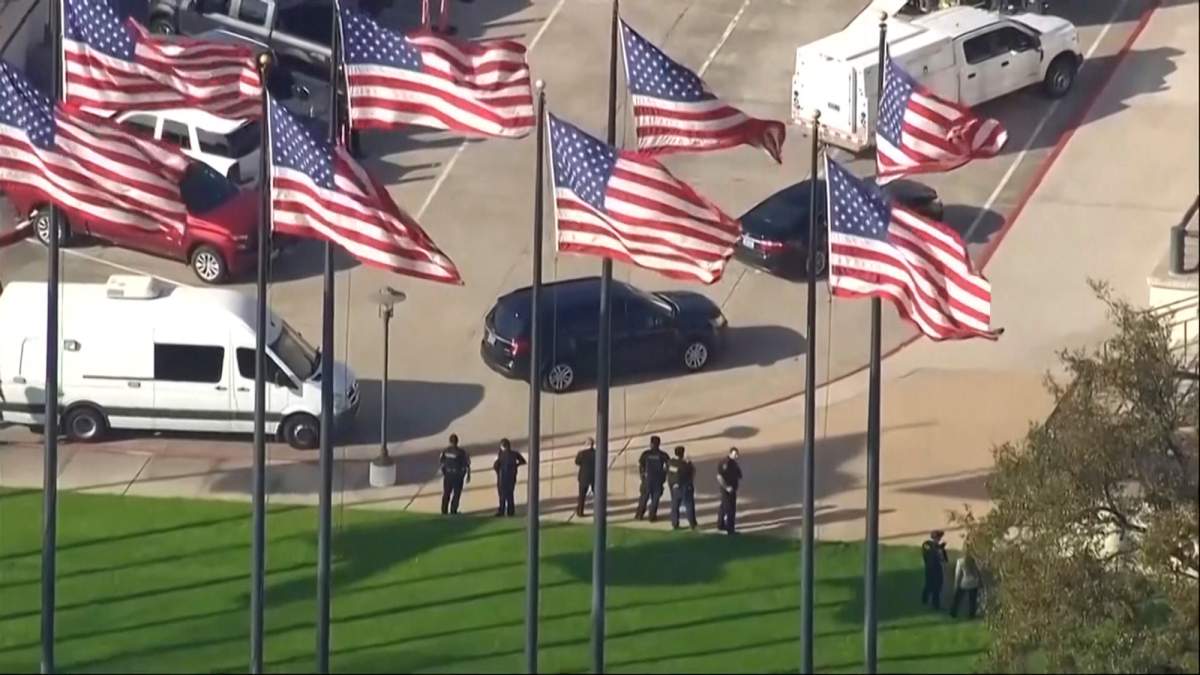 Police officers standing outside Lakewood Church.