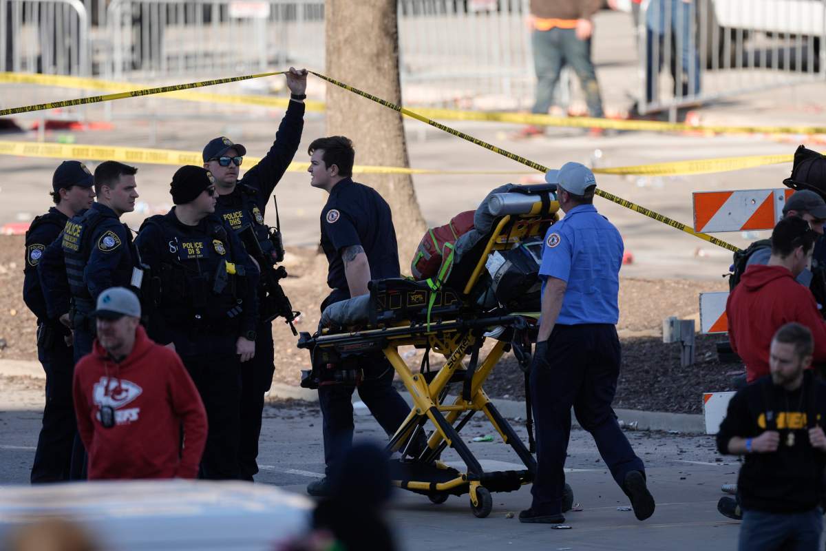 A person is taken to an ambulance after an incident following the Kansas City Chiefs victory parade in Kansas City, Mo., Wednesday, Feb. 14, 2024. The Chiefs defeated the San Francisco 49ers Sunday in the NFL Super Bowl 58 football game. (AP Photo/Charlie Riedel)