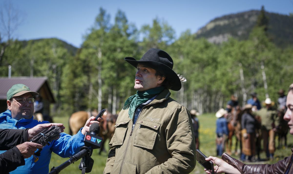 Singer Corb Lund, centre, speaks to the media on land proposed for coal mine development in the eastern slopes of the Livingstone range south west of Longview, Alta., Wednesday, June 16, 2021.