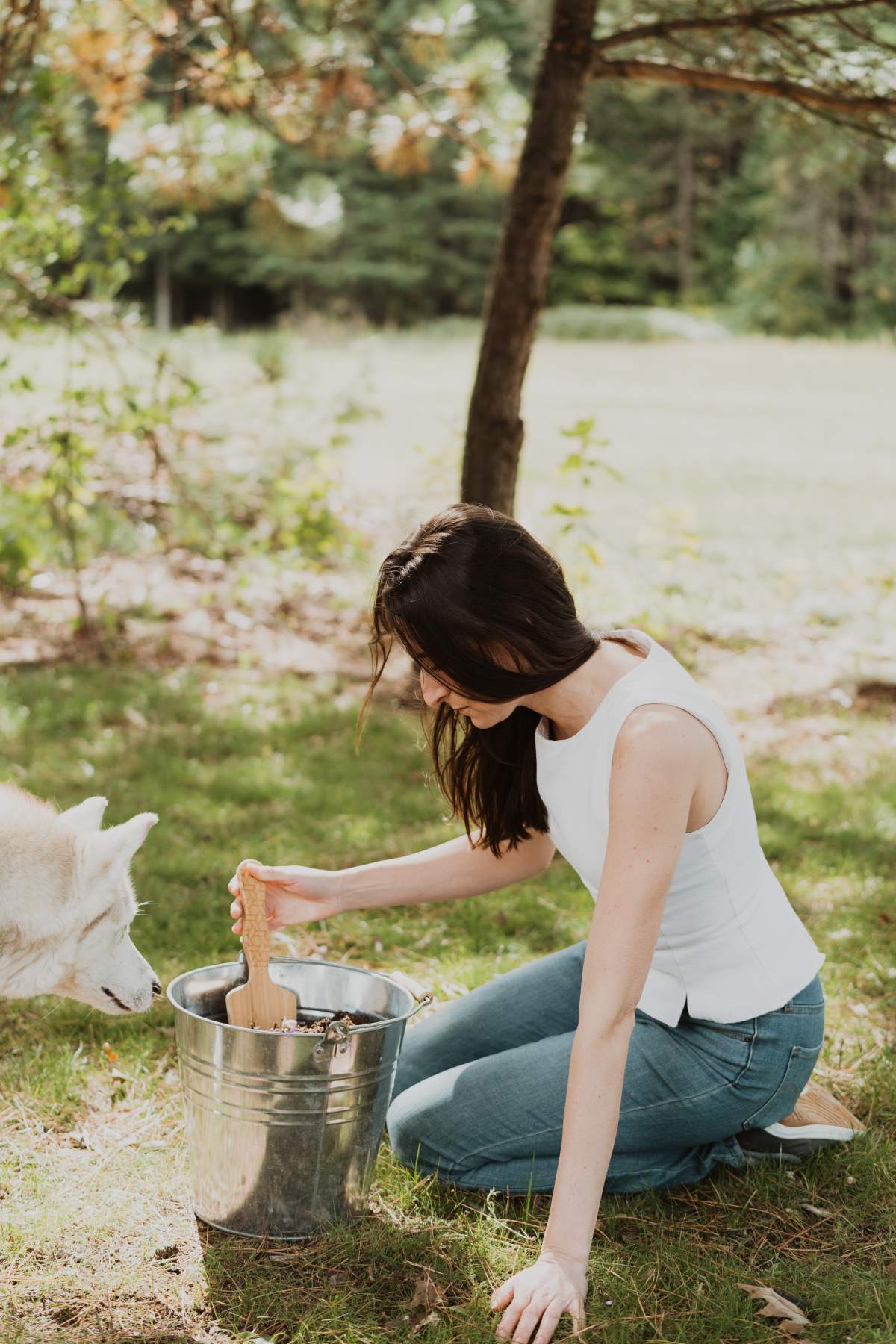 A person using a mix of soil and ashes for new plan growth.
