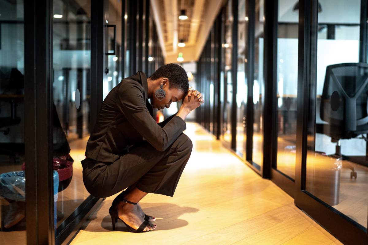 Worried young black businesswoman at corridor office for being fired