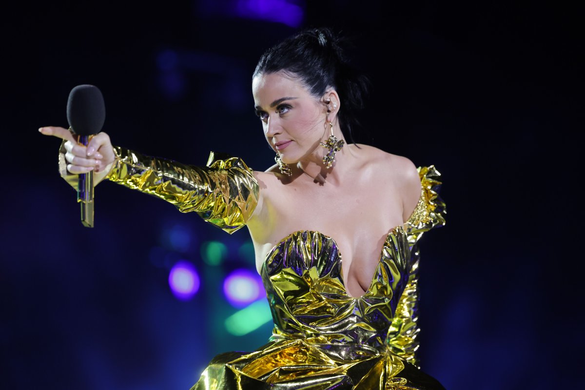 Katy Perry performs on stage is a metallic gold dress.