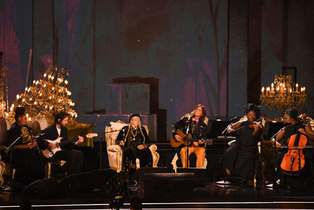 Canadian-US singer-songwriter Joni Mitchell (C) and US singer-songwriter Brandi Carlile (3rd R) perform on stage during the 66th Annual Grammy Awards at the Crypto.com Arena in Los Angeles on February 4, 2024.