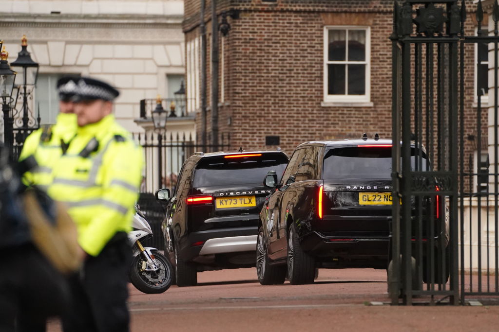 Two black SUVs, once carrying Prince Harry, arrive at Clarence House, London, following the announcement of King Charles III's cancer diagnosis on Monday evening.