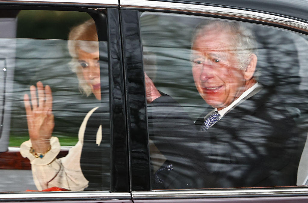 Britain's King Charles III and Britain's Queen Camilla wave as they leave by car from Clarence House in London on February 6, 2024. King Charles III's estranged son Prince Harry arrived in London on Tuesday after his father's diagnosis of cancer, which doctors "caught early".