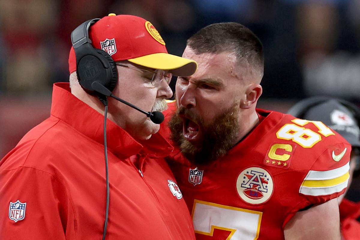 Travis Kelce shouts at Andy Reid, who has his eyes closed in the photo.