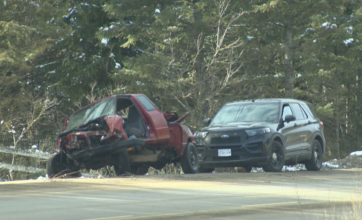 An unmarked police cruiser is parked behind one of the vehicles involved in Saturday's collision along Highway 33, east of Kelowna, B.C.