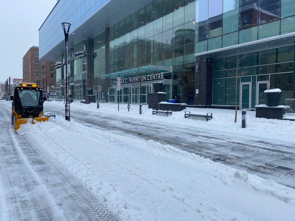 A snow plow works to clear off Argyle Street in downtown Halifax on Saturday morning, during a brief break in snowfall.