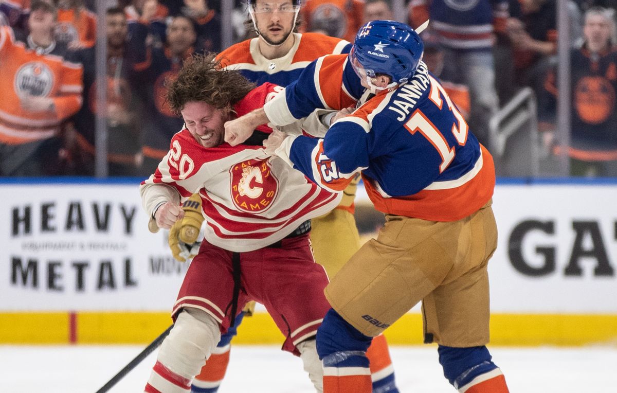 Calgary Flames' Blake Coleman (20) and Edmonton Oilers' Mattias Janmark (13) fight during second period NHL action in Edmonton on Saturday February 24, 2024.