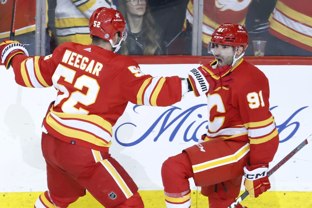 Calgary Flames' Nazem Kadri, right, celebrates his game-winning goal against the Boston Bruins with MacKenzie Weegar during overtime NHL hockey action in Calgary, Thursday, Feb. 22, 2024.