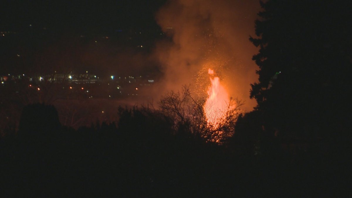 Flames and sparks rise from a house fire in Kelowna, B.C.