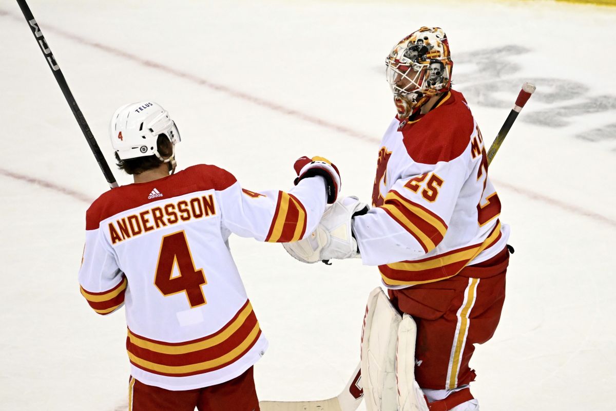 Calgary Flames goaltender Jacob Markstrom (25) celebrates with defenceman Rasmus Andersson (4) after the Flames defeated the New Jersey Devils in an NHL hockey game Thursday, Feb. 8, 2024, in Newark, N.J.