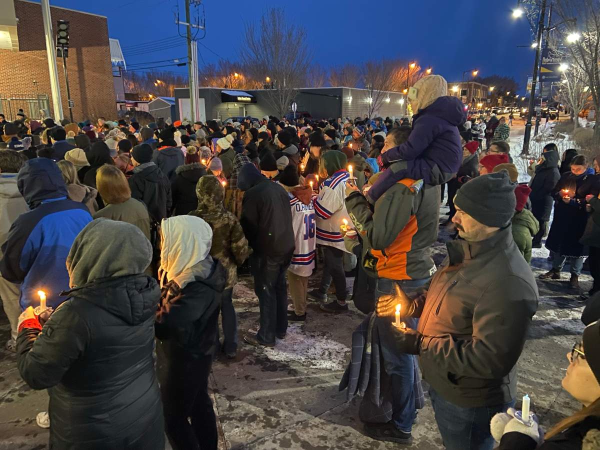 Hundreds of people at a candlelit vigil in Fort Saskatchewan, Alta. for Kassandra Gartner, who was killed in a hit-and-run in Edmonton on Feb. 24, 2024.