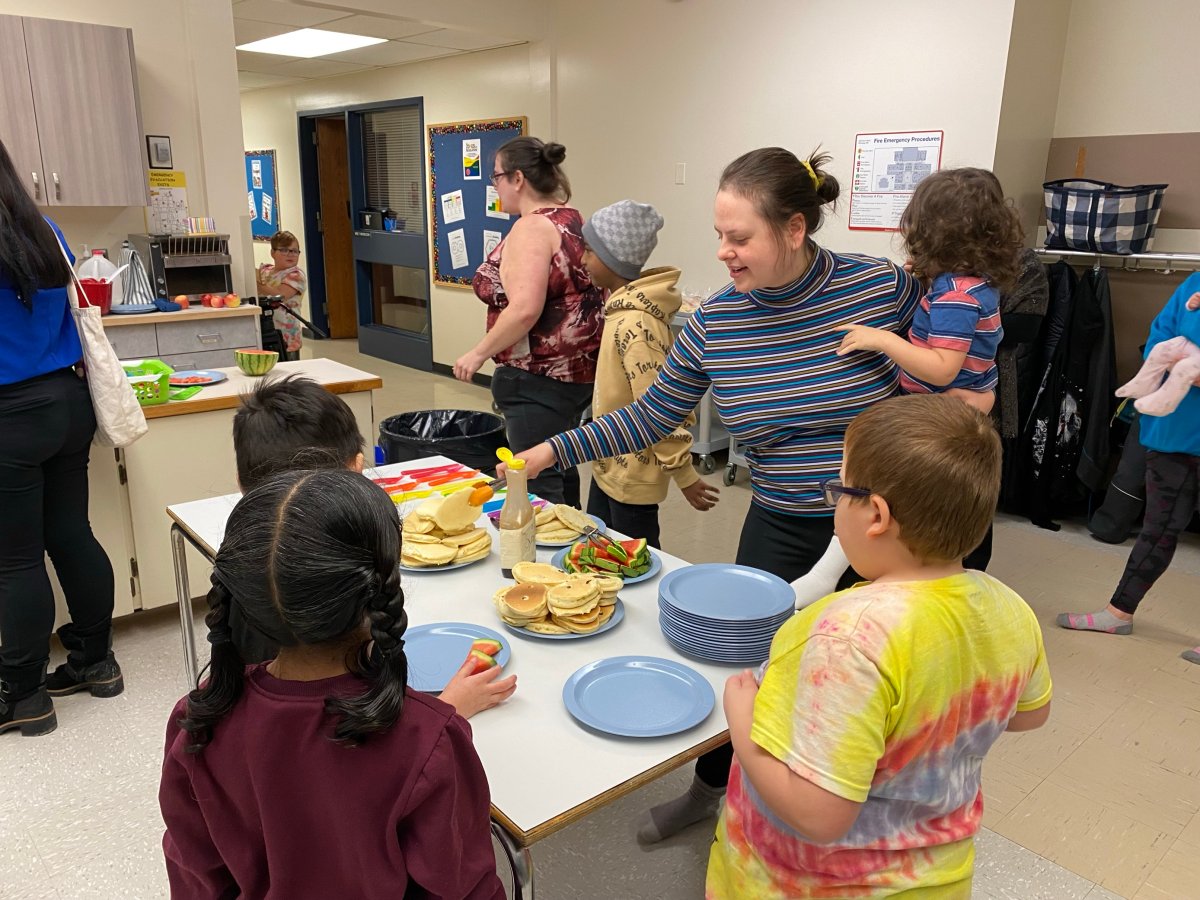Volunteers serve pancakes and fruit to kids at the Bertrun E. Glavin breakfast club.