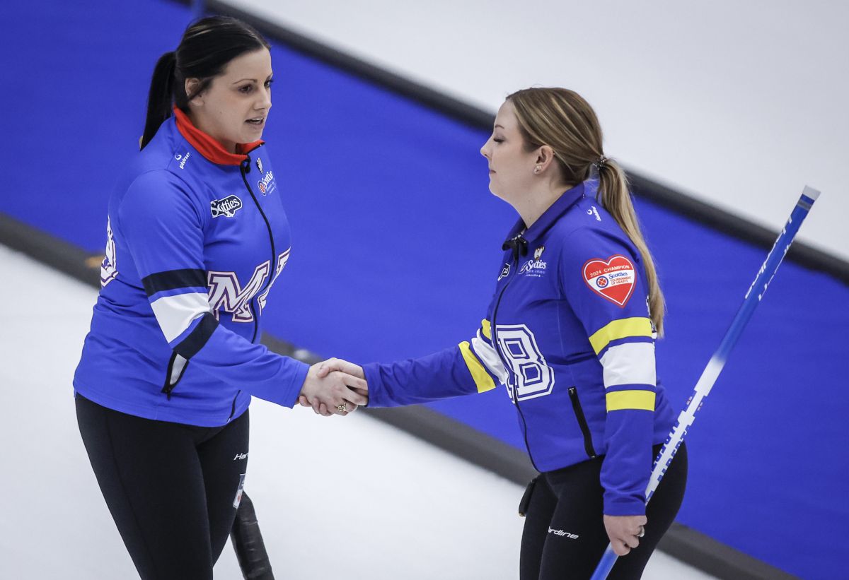 Team Manitoba-Cameron skip Kate Cameron, left, and Team Alberta skip Selena Sturmay shake hands following their draw in Page playoffs at the Scotties Tournament of Hearts in Calgary, Saturday, Feb. 24, 2024. Team Alberta lost to Team Manitoba-Cameron 6-4.